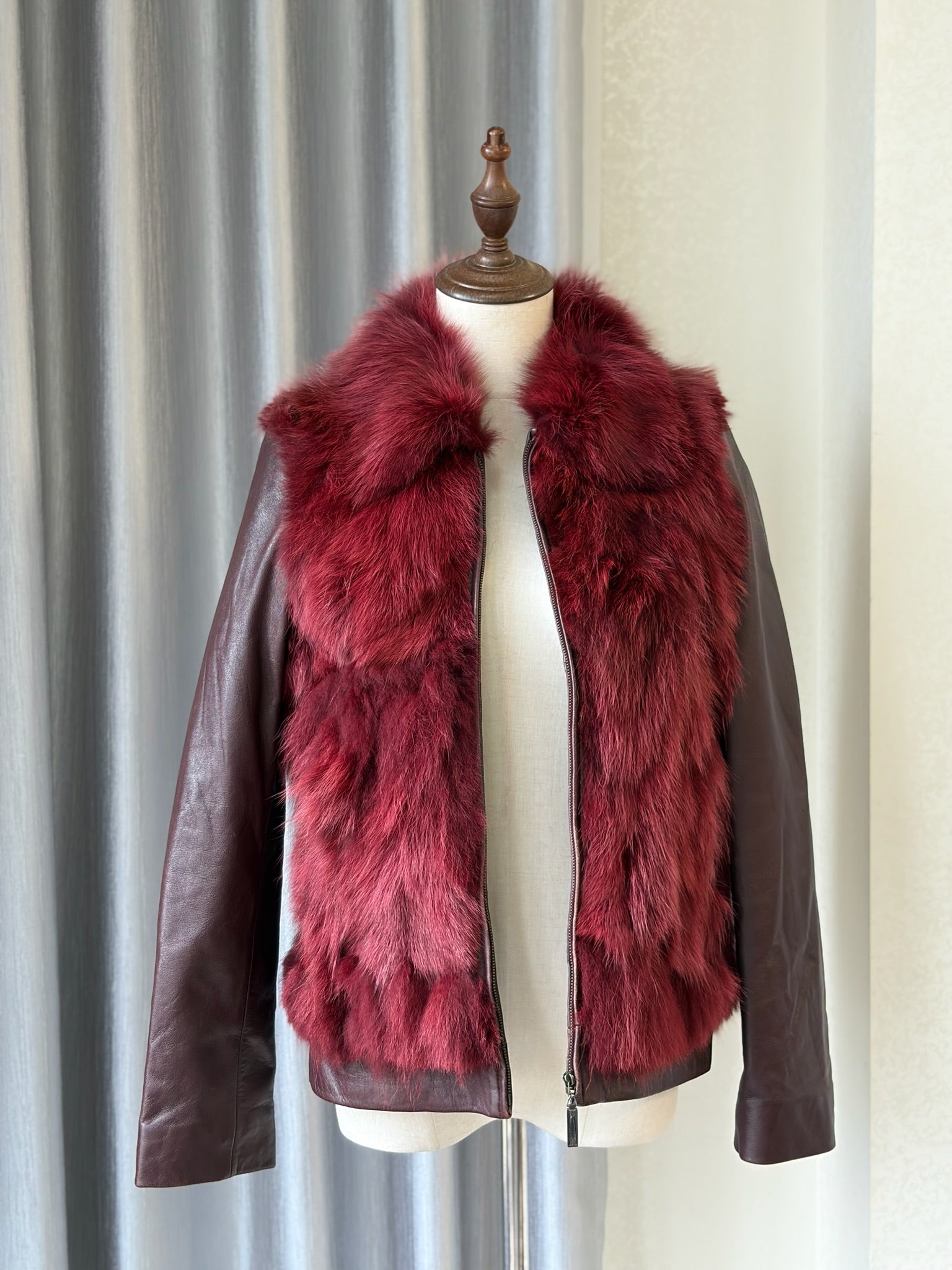 Wine red cropped jacket constructed with plush fox fur on front and collar,