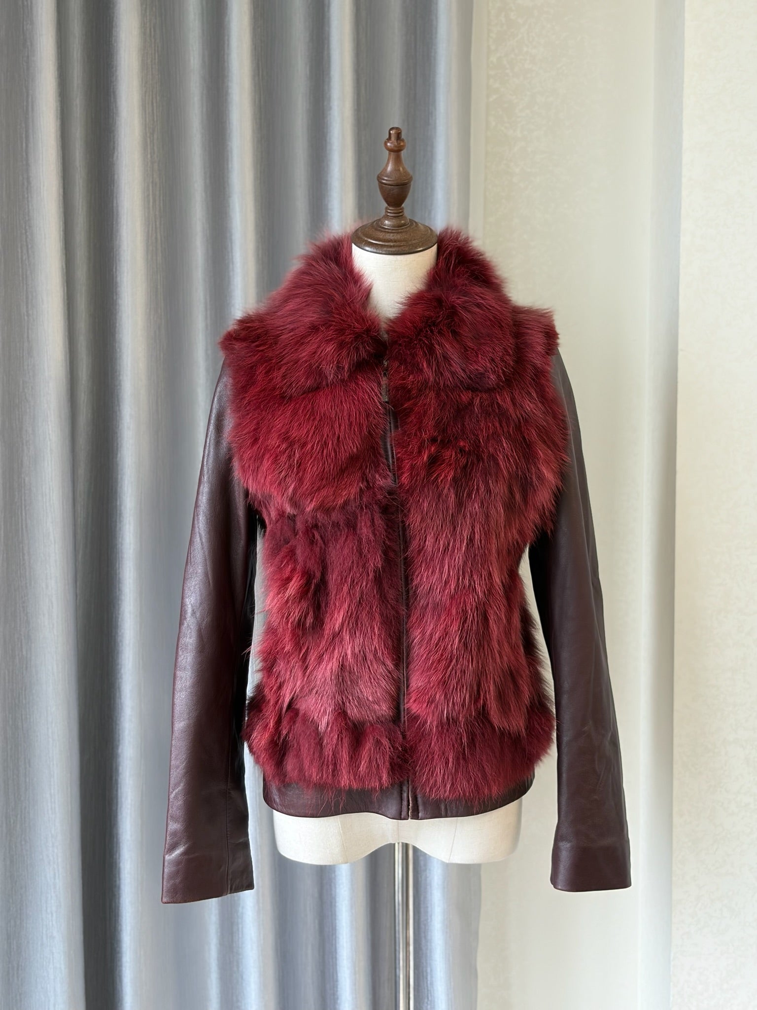Wine red cropped jacket constructed with plush fox fur on front and collar,