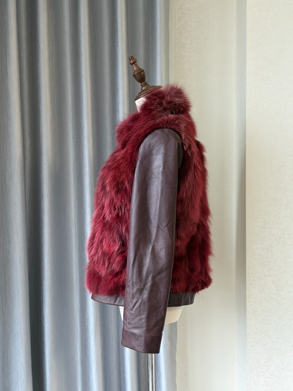 Wine red cropped jacket constructed with plush fox fur on front and collar,