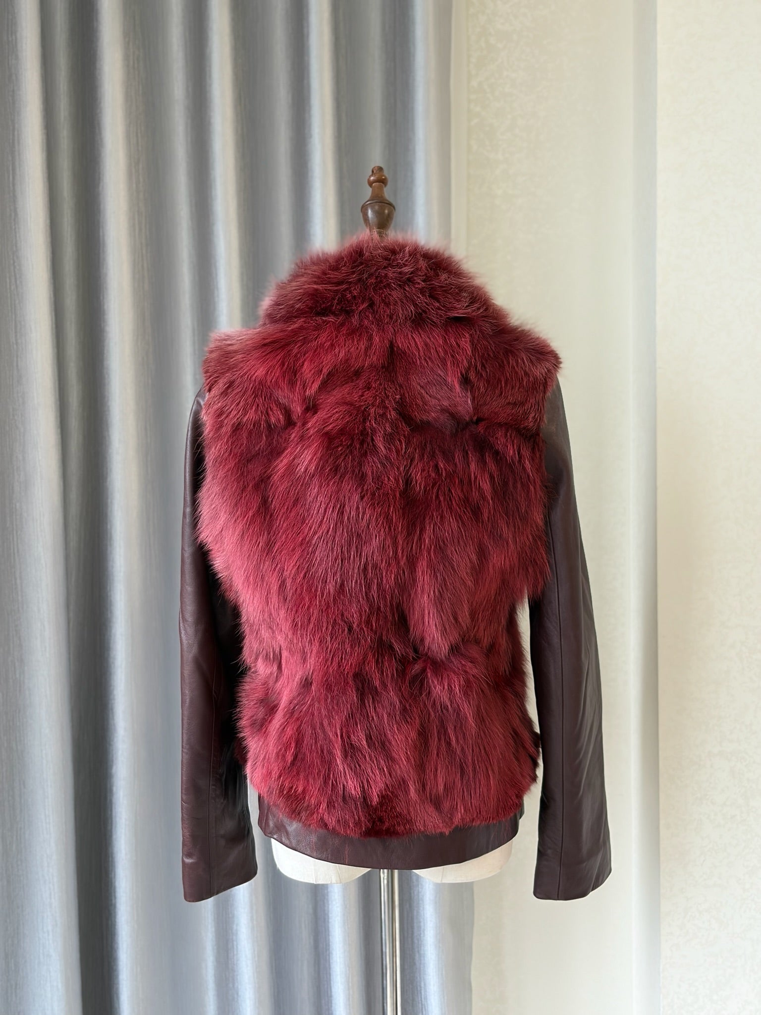 Wine red cropped jacket constructed with plush fox fur on front and collar,