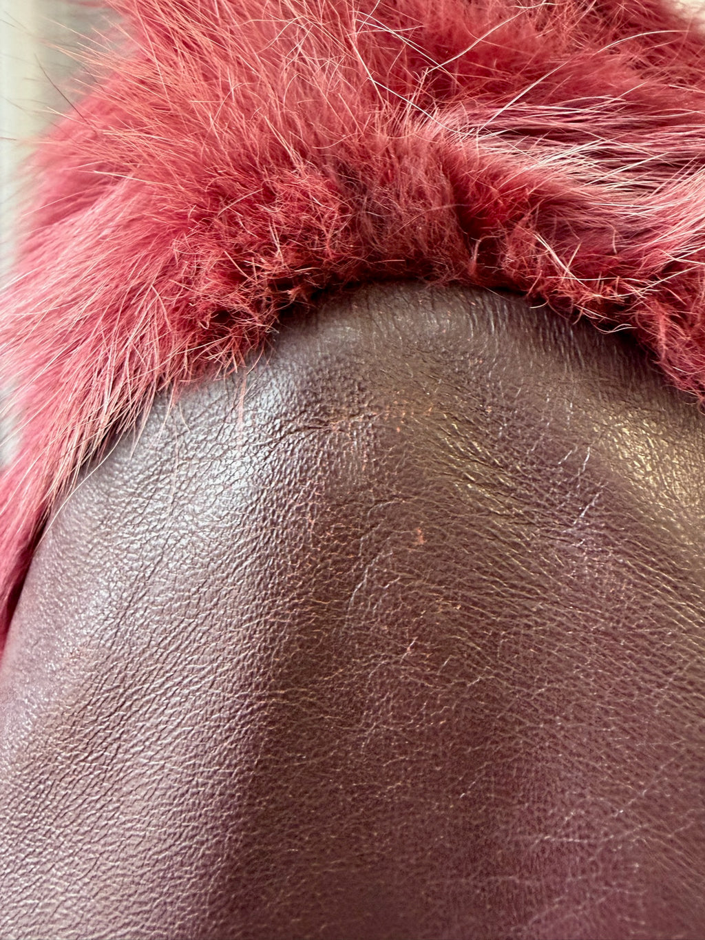 Wine red cropped jacket constructed with plush fox fur on front and collar,