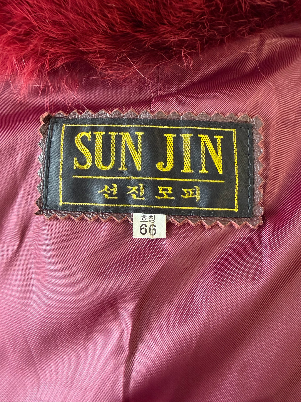 Wine red cropped jacket constructed with plush fox fur on front and collar,