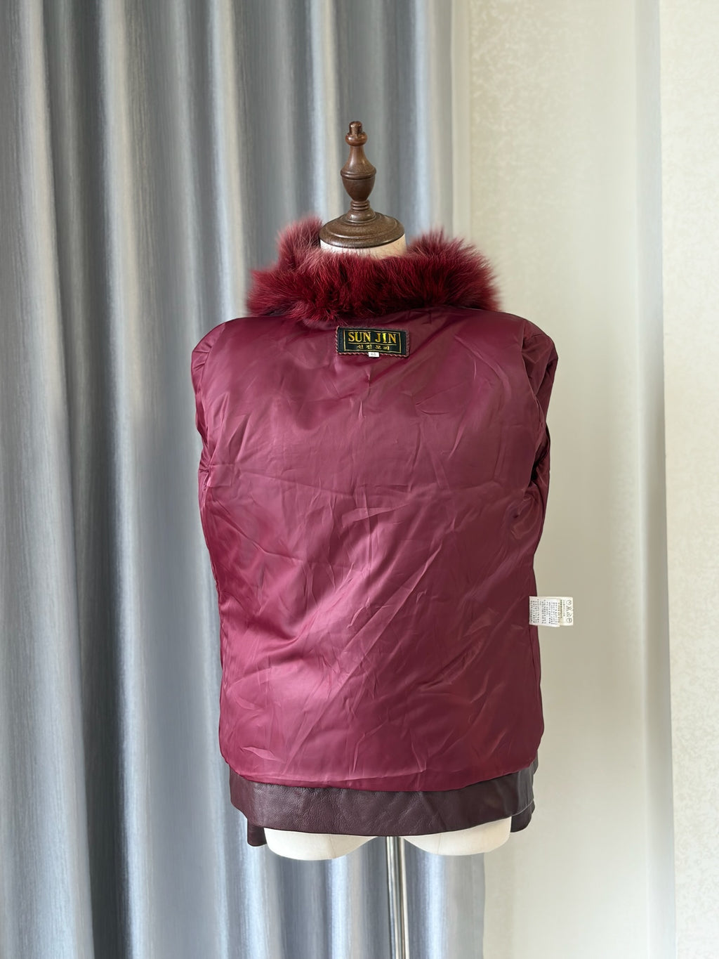 Wine red cropped jacket constructed with plush fox fur on front and collar,