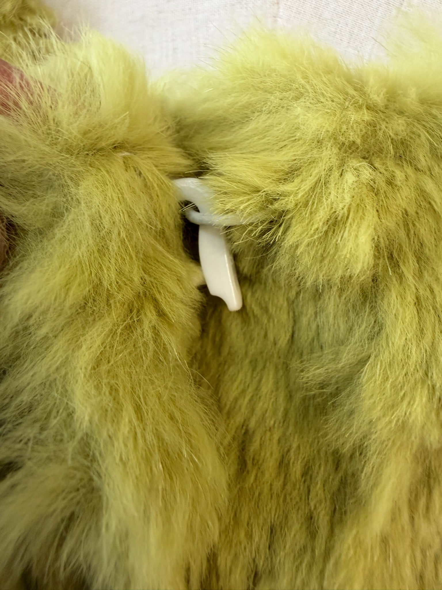 Mustard green rabbit fur textured mid-length fur coat features fluffy shoulder trim,