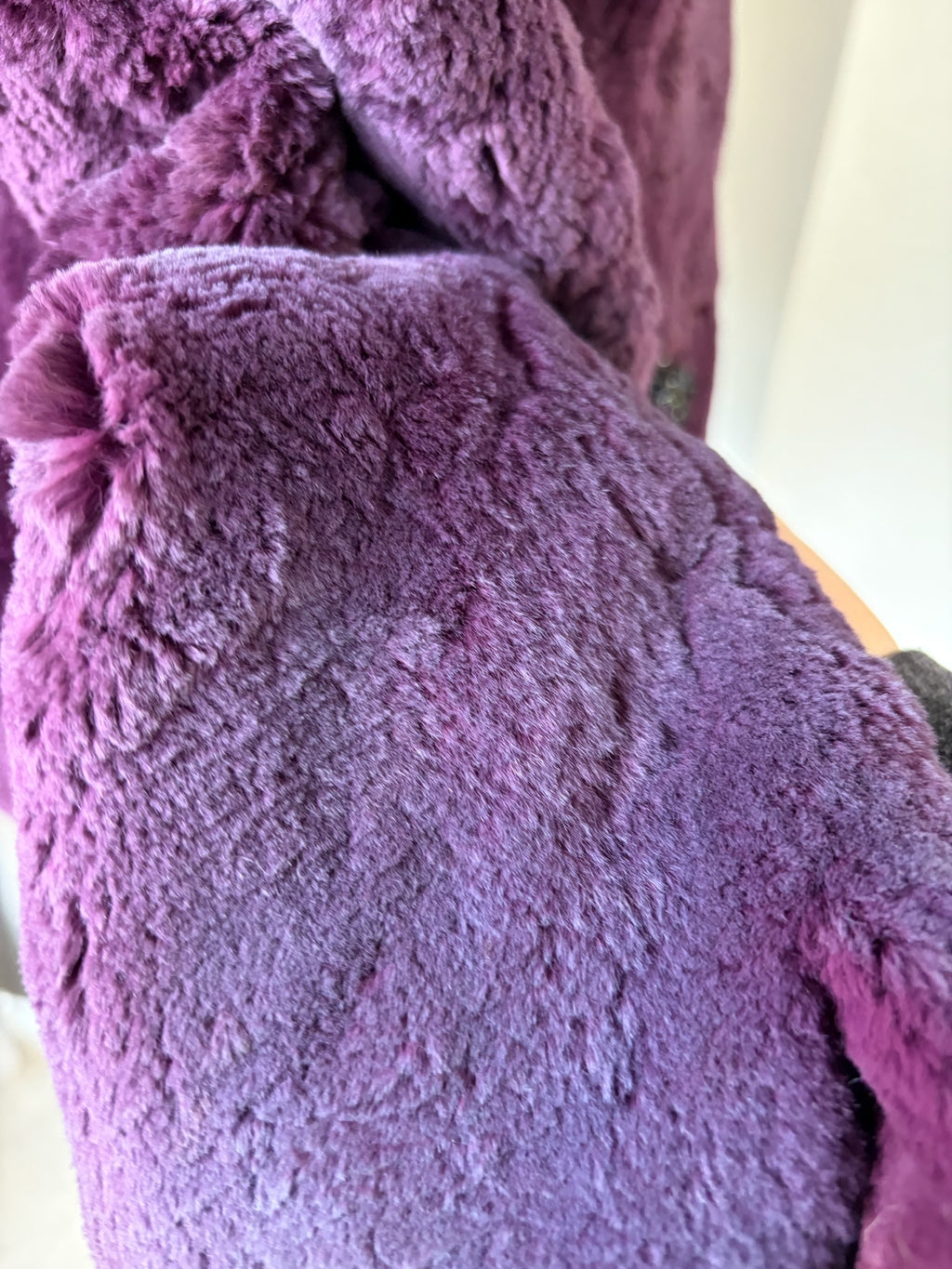Rich burgundy rabbit fur cropped jacket paired with oversized fluffy fox fur lapel