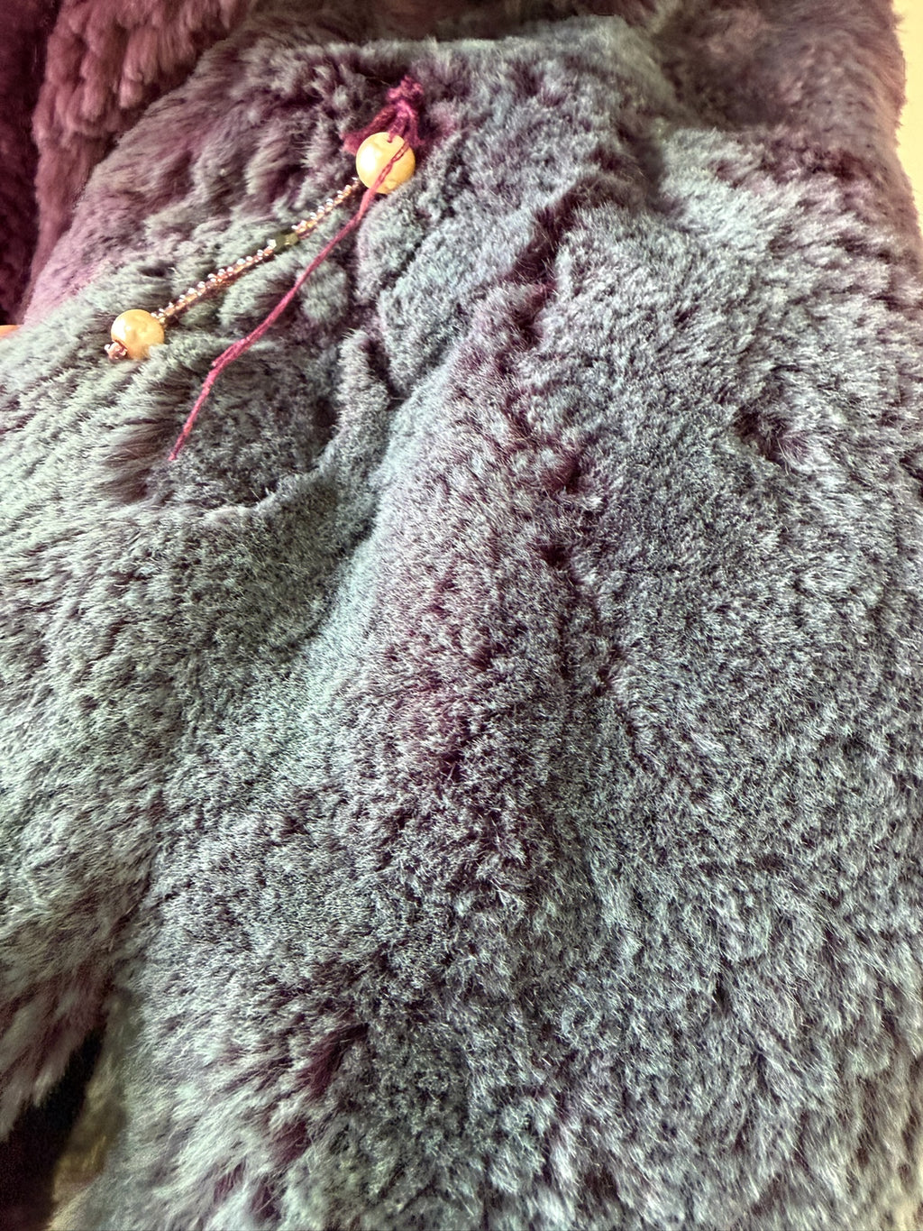 Rich burgundy rabbit fur cropped jacket paired with oversized fluffy fox fur lapel