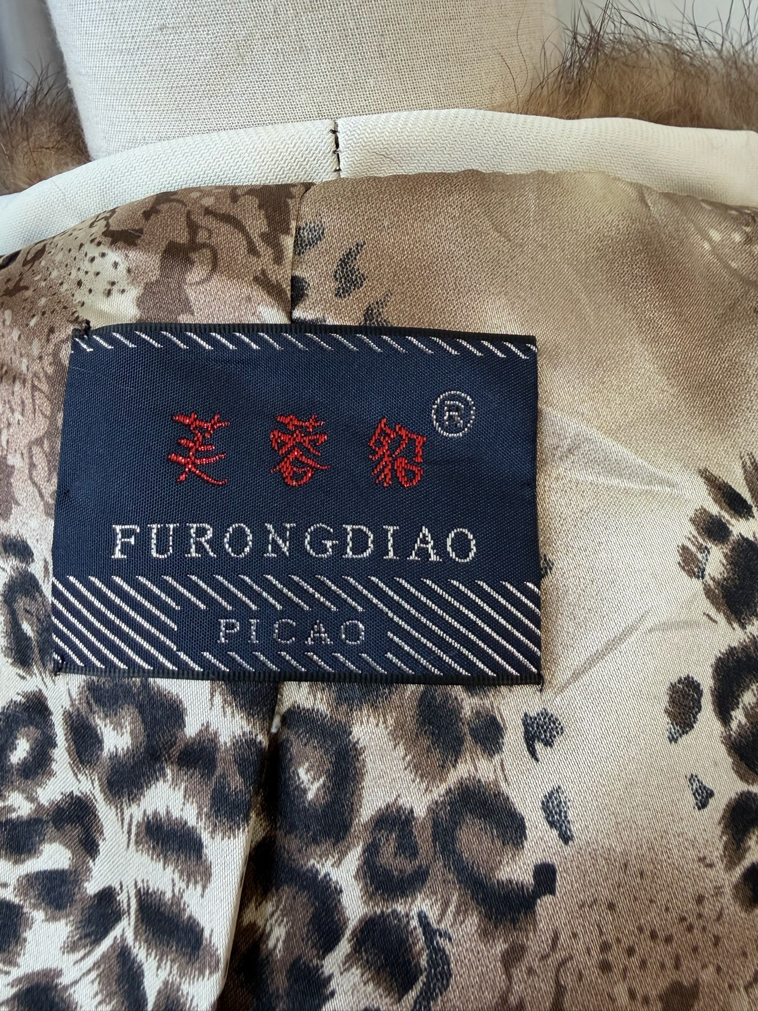 Off-white horizontally segmented cropped fur coat